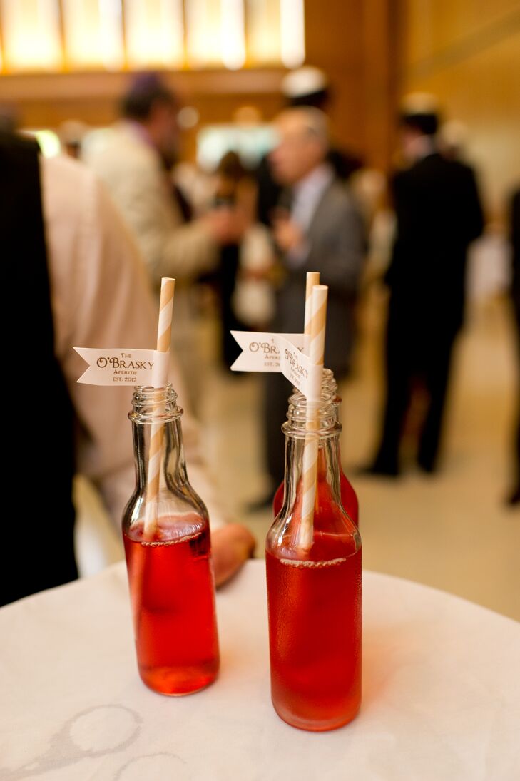 Sarah and Michael served sweet red signature drinks in glass bottles, complete with cheerful striped straws with custom labels for guests to sip out of.