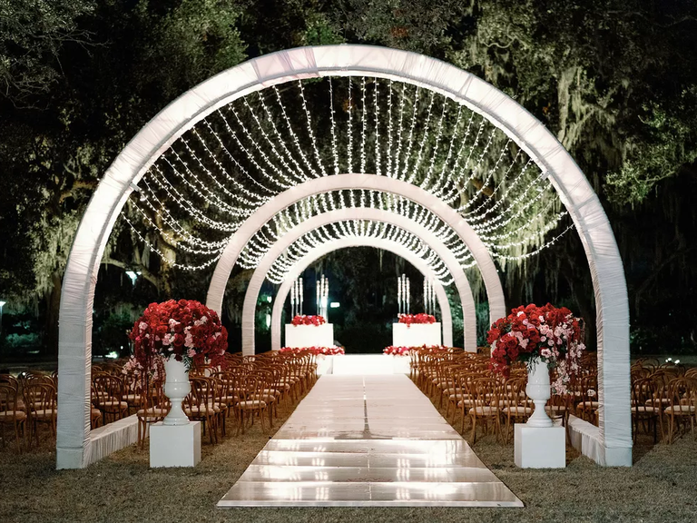 These delightful twinkling fairy lights bring a fantastical feeling to this wedding aisle.