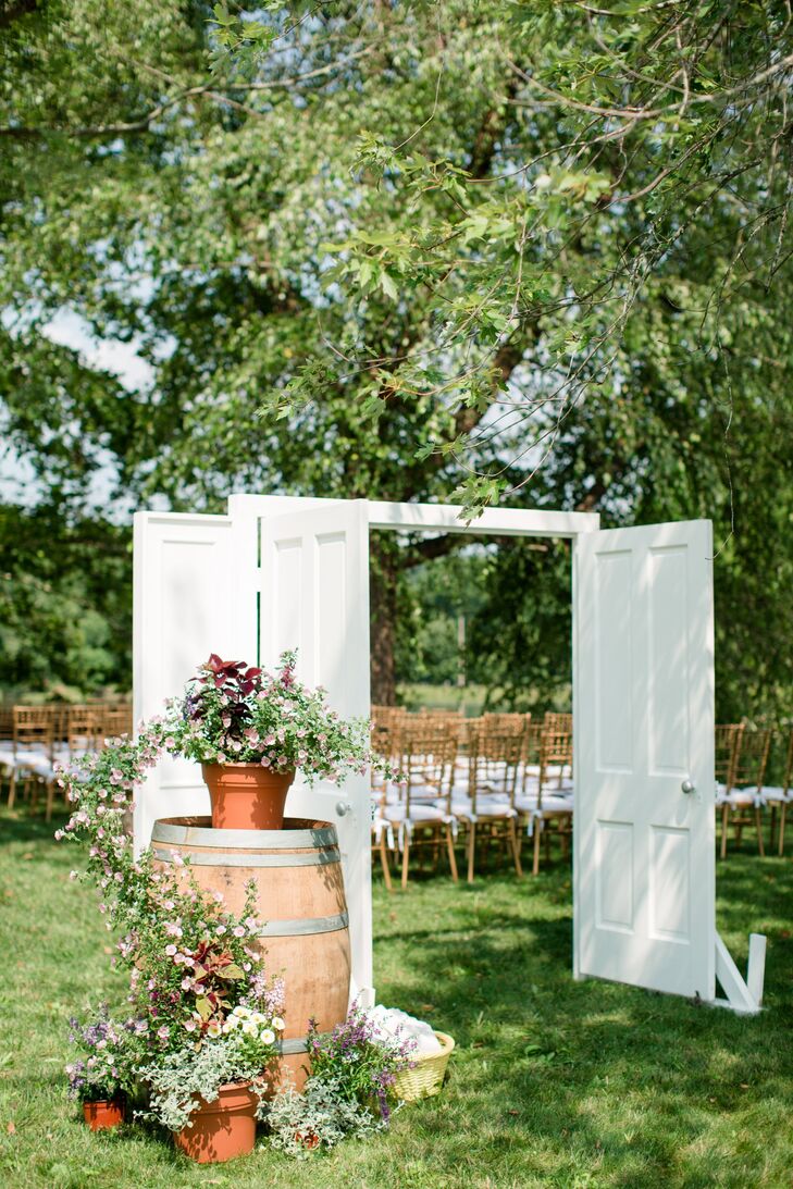Large freestanding white doors that opened onto the aisle added a unique touch to the ceremony decor.