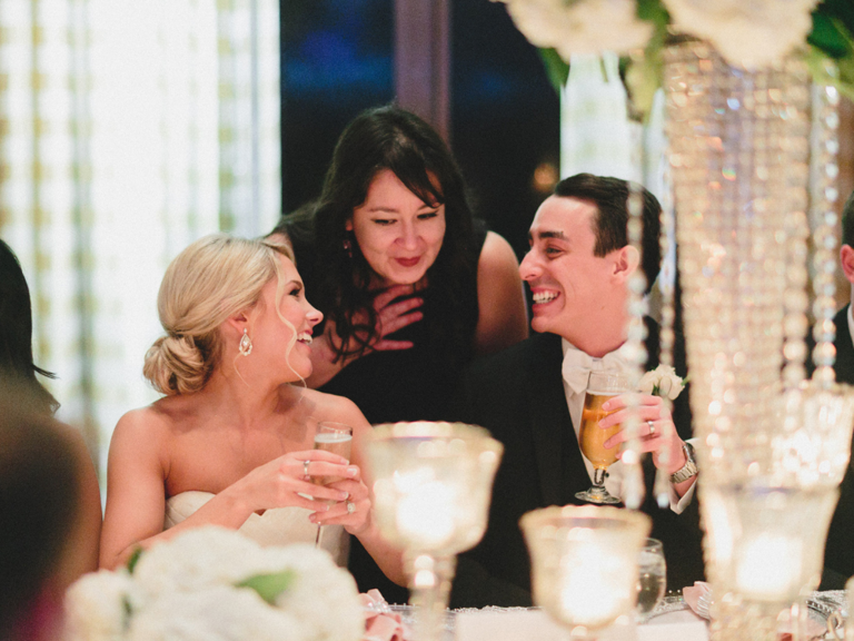 wedding planner talking to couple during wedding reception