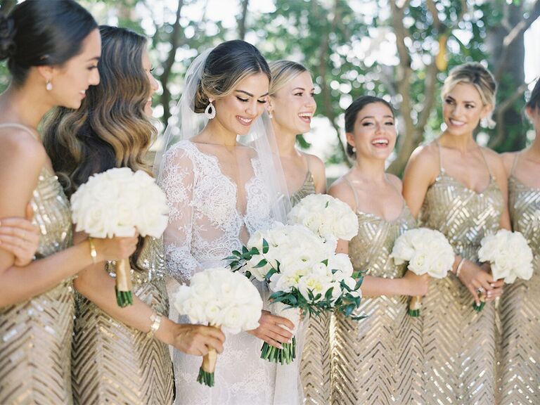 bridesmaids posing in gold beaded dresses
