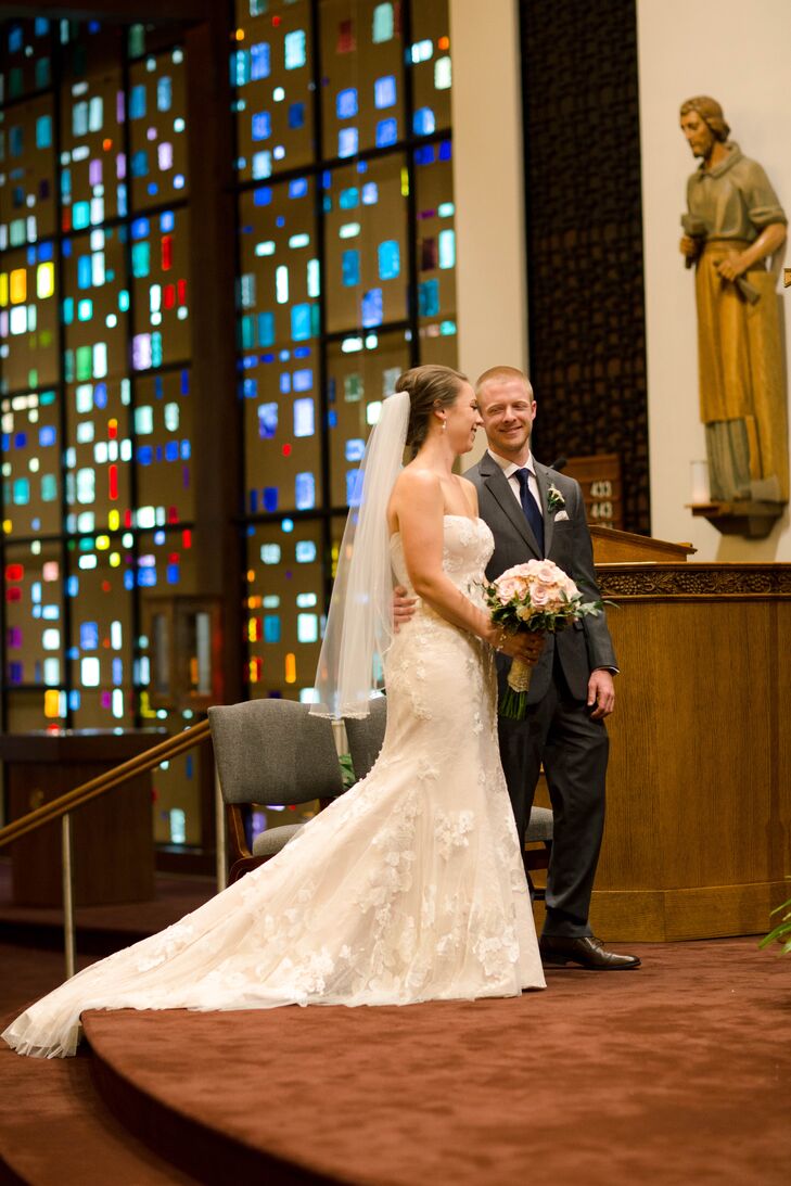 Chris matched Emily’s ivory lace trumpet-style dress with an equally chic look. He picked out a gray Calvin Klein suit from Men’s Wearhouse and a navy tie to bring in their wedding color.
