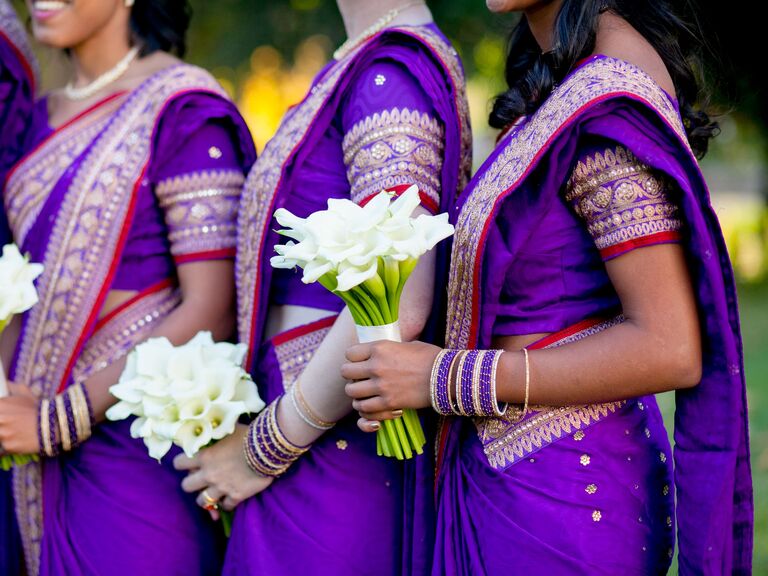 Rich purple and gold bridesmaids wedding saris.