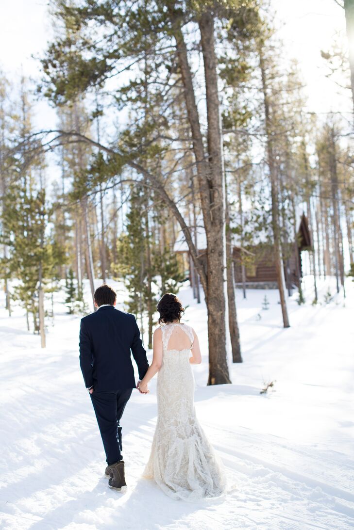 Kristen wore a champagne Marisa wedding dress with a white lace overlay and keyhole back for her January wedding. For the ceremony, she also wore a white fur cape to keep warm in front of the open barn doors.