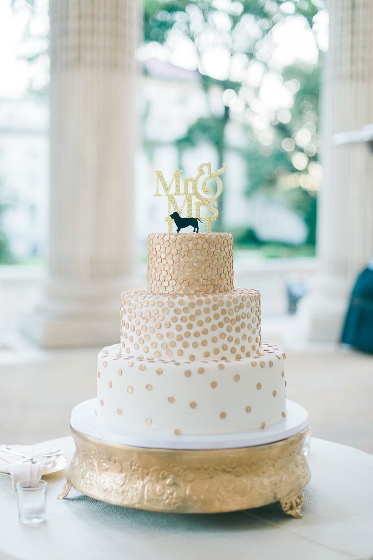 The wedding cake was flavored with strawberry cream and chocolate hazelnut. It was decorated in gold and featured a basset hound topper that represented Erin and John's pet dog.