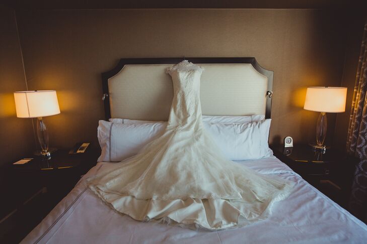 Dongli wore an ivory wedding dress with a high illusion neckline, accented with lace all the way down the mermaid-style silhouette to where the skirt flared out at the bottom.
