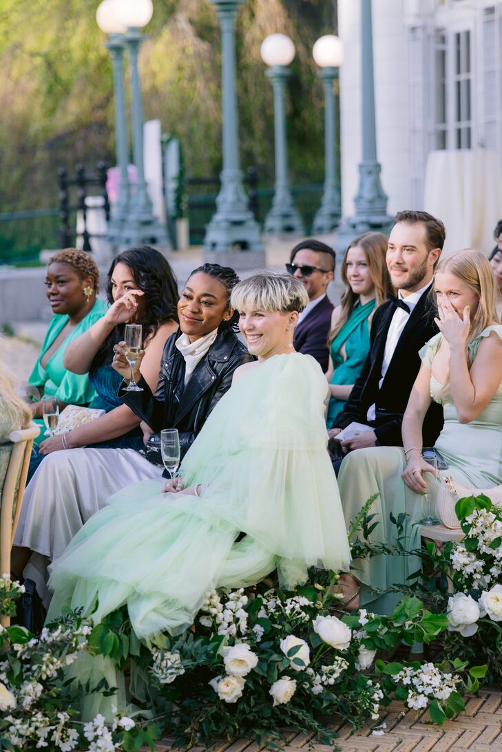 Fashionable Ceremony Guests With Drinks Watching Vows, Emotional