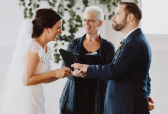 Bride and groom and officiant at wedding ceremony