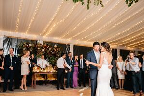 First Dance in Tented Reception Space Lined with Overhead Lighting