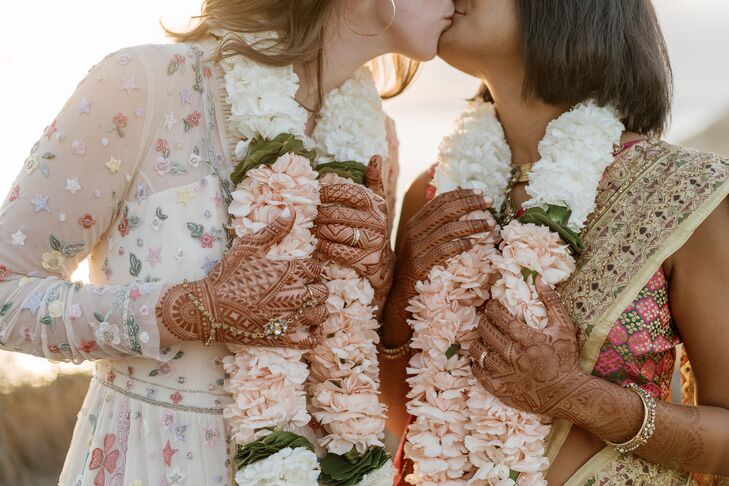 Couple With Henna and Marigold Garlands Kissing
