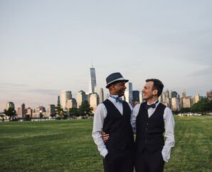 Grooms In Front of Skyline During Sunset