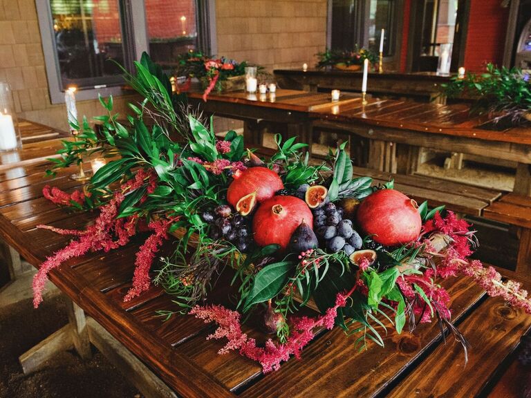 Pomegranate red fig black grapes greenery flower wedding table arrangement