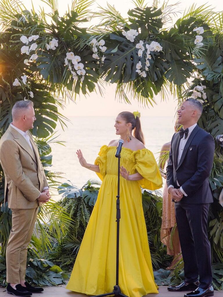 Drew Barrymore wears a bright yellow gown at her friends tropical wedding. 