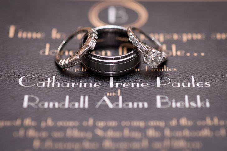 Catharine's ring is an old mine cut diamond which Randy had purchased on its own. He had the stone combined with an art deco vintage setting which inspired the wedding theme. Her wedding ring carried the same art deco inspiration.