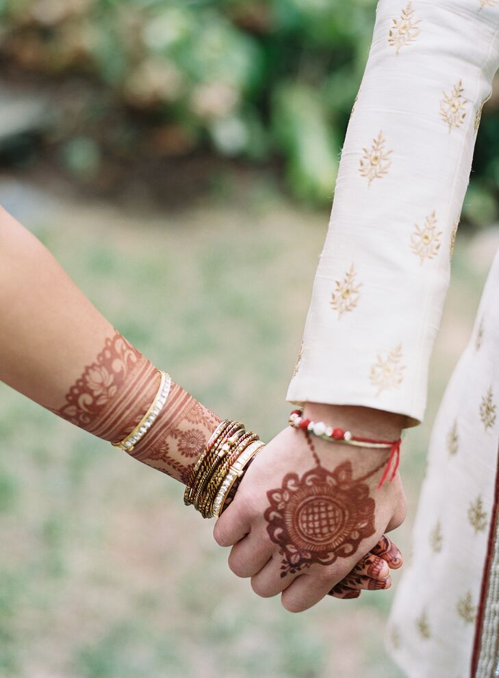 Couple with Henna Holding Hands During Wedding