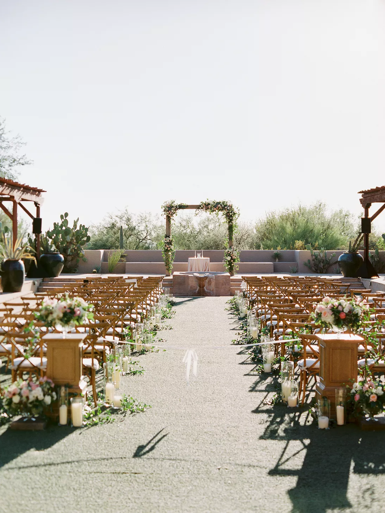 A sunny day wedding arch stands ready for the "I dos".