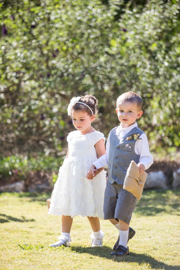 Sarah and Nate's flower girl and ring bearer couldn't have been cuter. Their outfits reflected the vintage vibe of the wedding, with the flower girl in a tea-length white dress and floral headband and the ring bearer in an adorable seersucker vest and shorts.