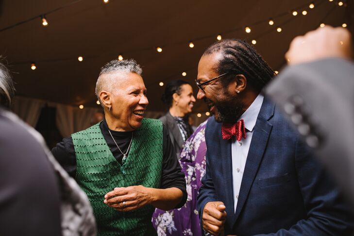 Guests Smiling and Laughing With One Another on Dance Floor Under Tent