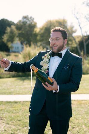 Groom Sabering Champagne at Inn at Perry Cabin in St. Michaels, Maryland
