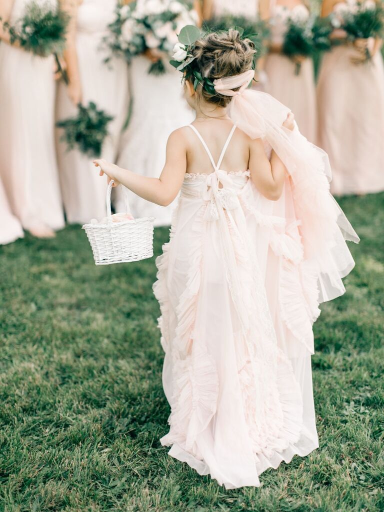 Flower girl wears her hair in a whimsical updo. 