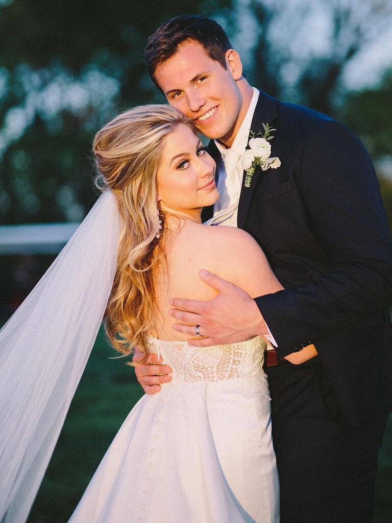 Shawn Johnson and husband Andrew East hugging each other on wedding day