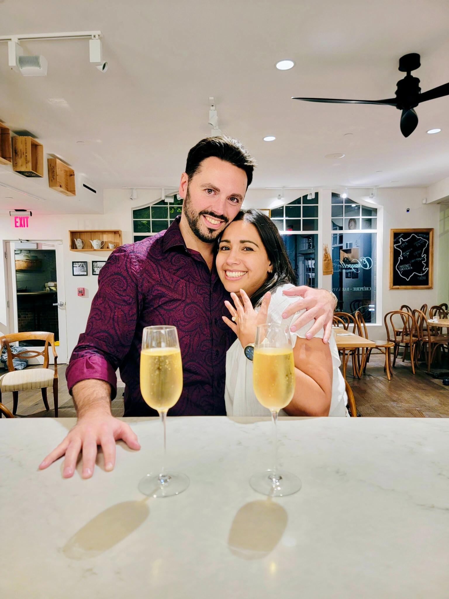 Two months later...officially engaged! After having a great time celebrating my birthday with some wine and crepes, Craig completely blindsided me by getting down on one knee right outside the cafe! To quote Craig: "I was waiting for the just right moment and you were so happy as we were leaving that I knew it was the right time." Little did I know Craig had been carrying that ring from one place to another since August waiting for the perfect moment! This photo is from inside the cafe after hours when we were invited back in for a glass of champagne to celebrate!