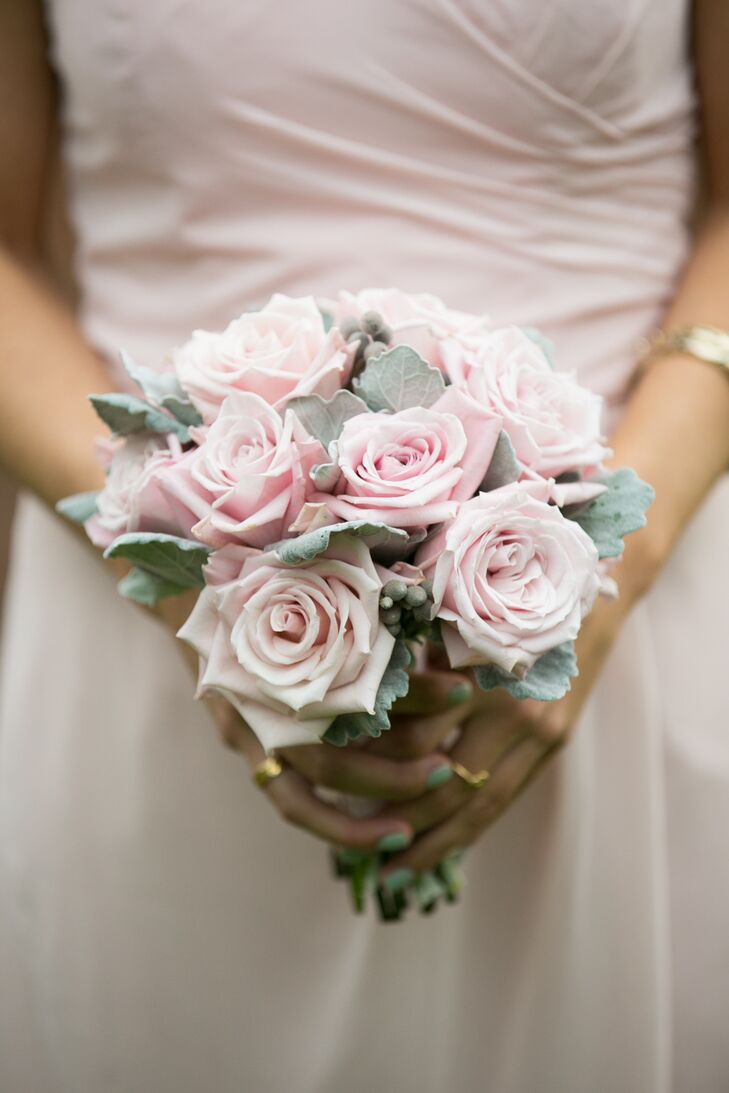 Bridesmaids carried romantic arrangements of blush-colored roses and dusty miller to complement the shade of their Bill Levkoff dresses.