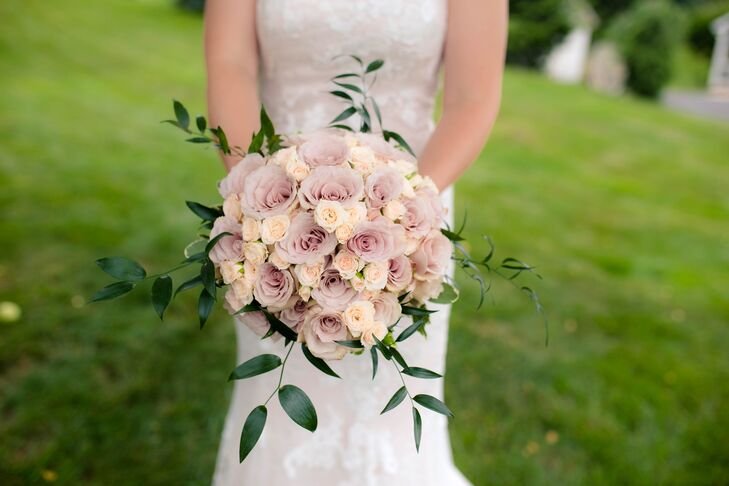 Thomas and Elliot Hoy from the Details Matter took pictures of Emily and her bridesmaids and made vintage-inspired bouquets. Emily's arrangement was filled with spray roses (one of her favorite flowers). Ivory spray roses were set in between mauve roses, then surrounded by a halo of eucalyptus for a refined twist on a natural arrangement.