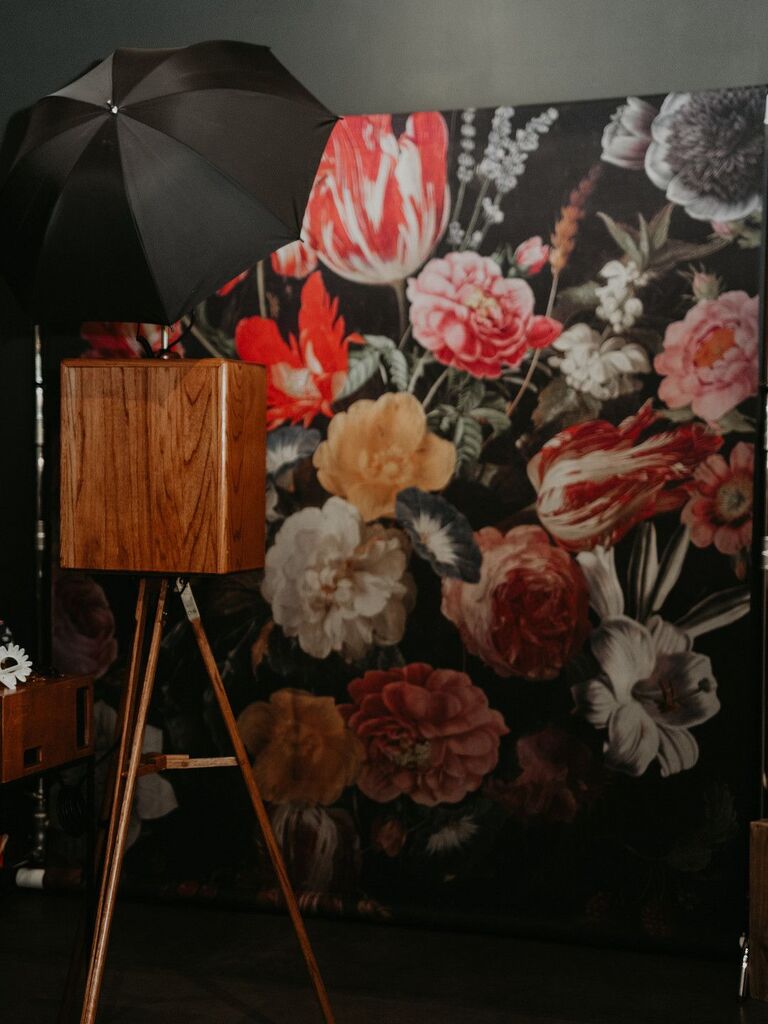 Vintage photo booth with floral wallpaper backdrop