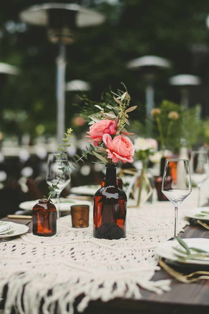 In addition to the vintage brown glass bottles, some tables were adorned with an ivory macrame runner from Anthropologie.