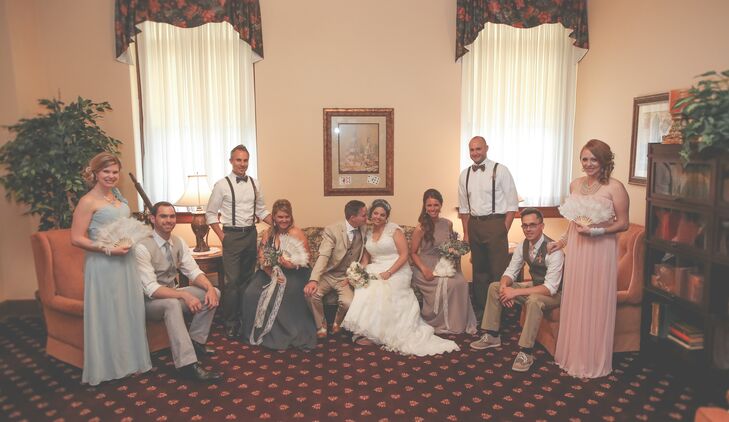 In keeping with the vintage aesthetic, Jessica's bridesmaids wore long pastel chiffon dresses and accessorized with strings of pearls, feather fans, and parasols. The groomsmen wore different suits with classic bow ties, suspenders, and oxfords.