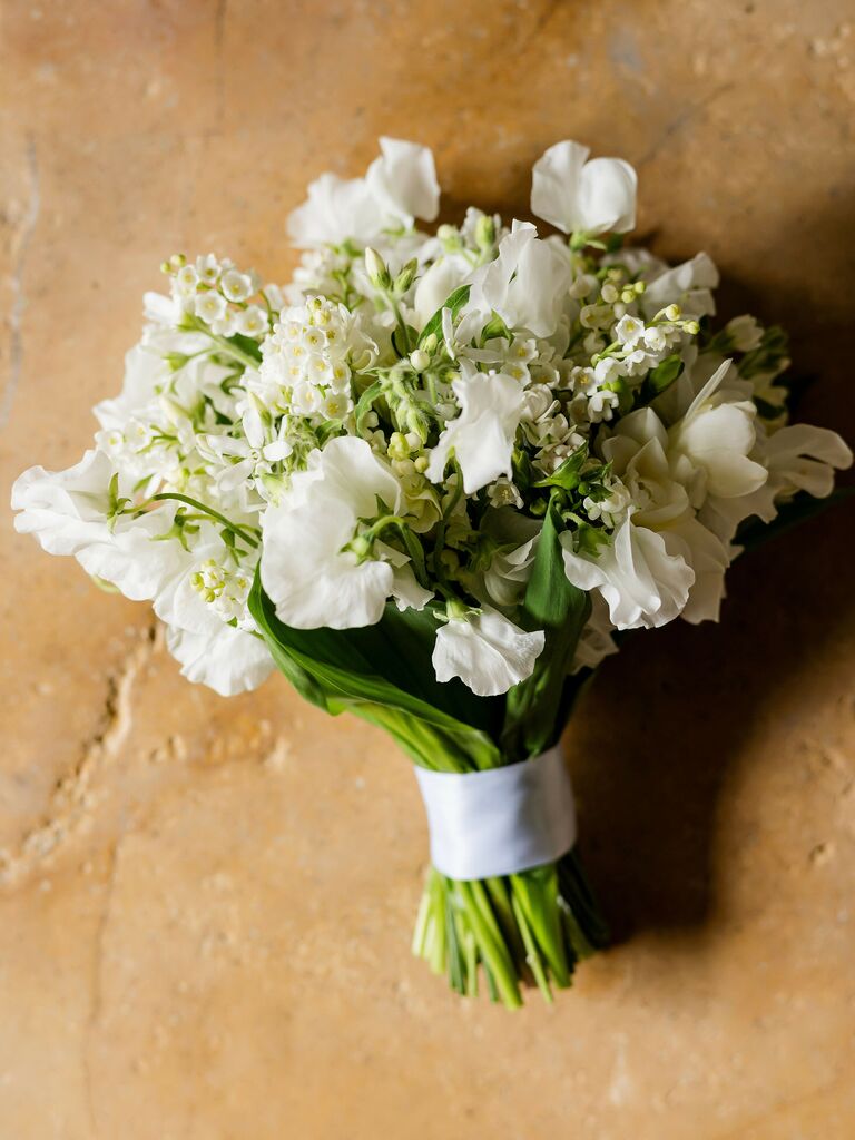 small wedding bouquet with white sweet peas and wax flowers