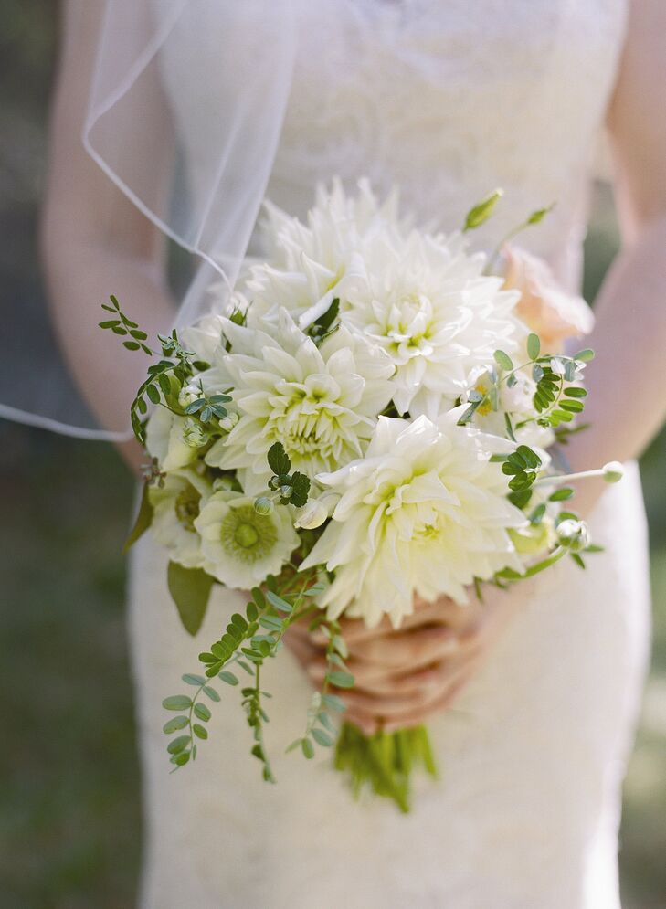 Caitlin's green and white bouquet of dahlias was wrapped in the lace from her mother's wedding dress. She also pinned both of her grandmothers' engagement rings as well as her great grandmother's locket to the bouquet for something old.