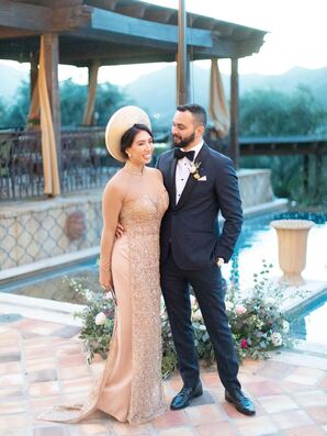 Bride in Vietnamese Ao Dai Posing With Groom in Suit Beside Pool