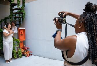 A wedding photographer taking a photo of the happy couple