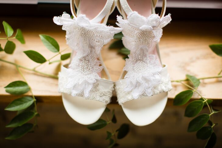 Anna completed her simple modified A-line wedding dress with ornate shoes. She loved the white flower detailing and pearl accents that added a little vintage flair to her look.