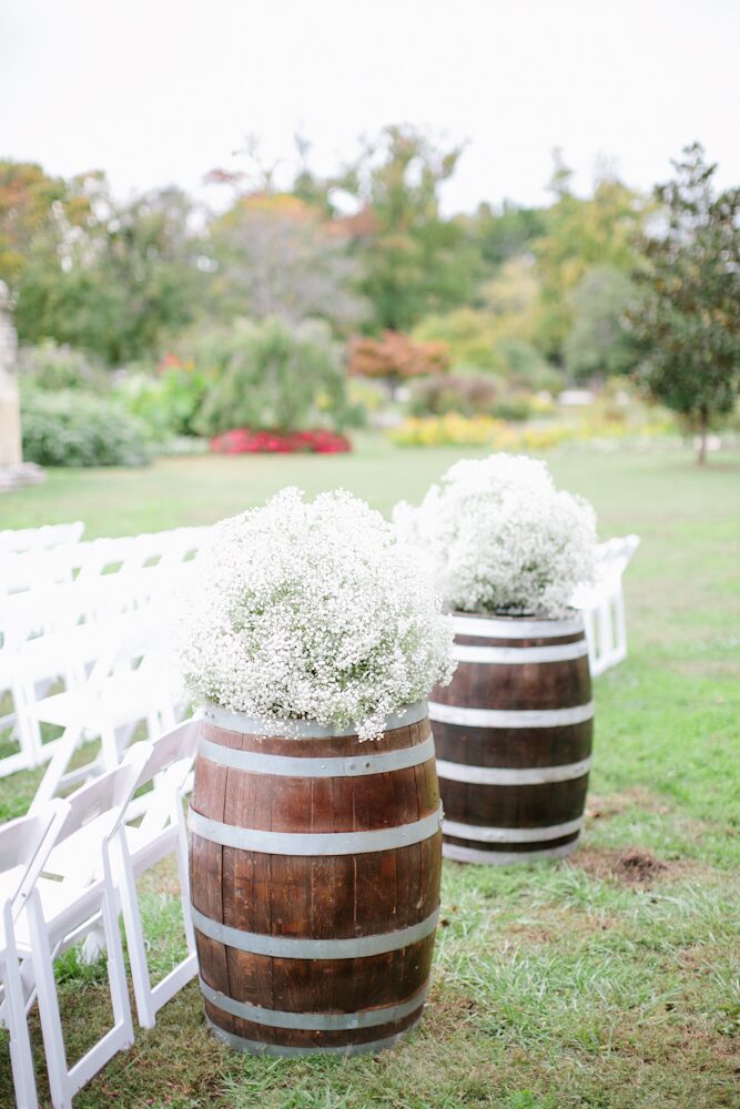 The ceremony aisle was framed with two dark-wood wine barrels topped with lush, overflowing white baby’s breath arrangements. “Growing up I loved spending time on our front porch, surrounded by my mom’s garden and birds enjoying food from the bird feeder,” Jessica says. “I wanted my wedding to feel like I was sitting in my mom’s garden.”