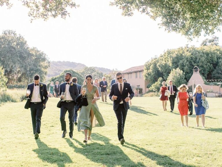 wedding guests walking during outdoor reception