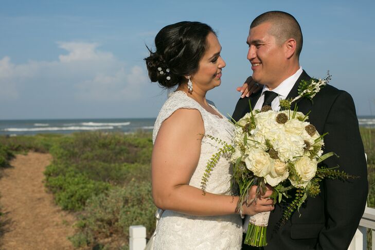 Natalie's bouquet had ivory roses and hydrangeas with scabiosa pods and whimsical, wild greens that evoked the beachy atmosphere of her wedding reception at Namar Event Center in South Padre Island, Texas.