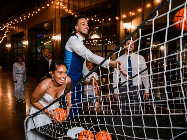 Couple playing basketball at wedding reception