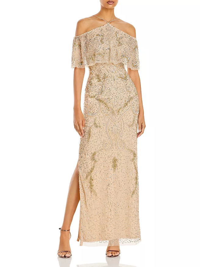 A model wears this halter-neck gold mother of the bride gown.