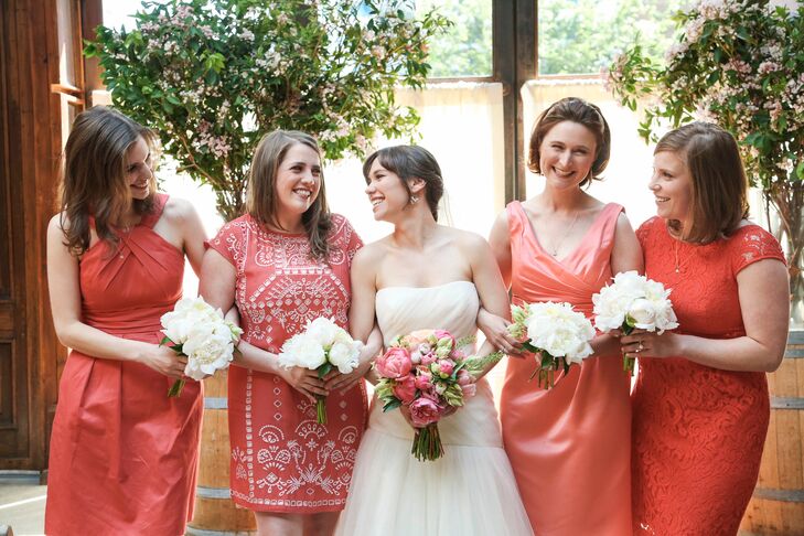 Emma let her bridesmaids have fun with their wedding day look by letting them choose their own dresses in a lively shade of coral. The diversity among their dresses played up the day’s laid-back feel, while bringing a bright punch of color and personality to the ceremony.