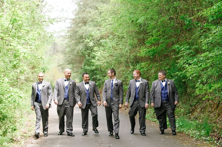 Marc chose a dark gray suit with a blue vest, tie and pocket square and a trio of white flowers in his boutonniere. The groomsmen wore blue bow ties, vests and a single white flower boutonniere.