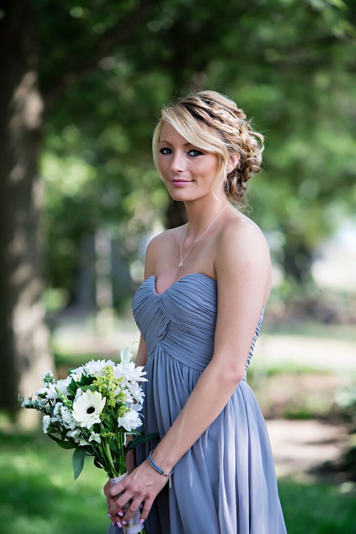 The bridesmaids wore mismatched "Sterling" blue-gray dresses by Donna Morgan from Nordstrom. They also wore black pumps and carried bouquets of white wildflowers, like gerbera daisies.