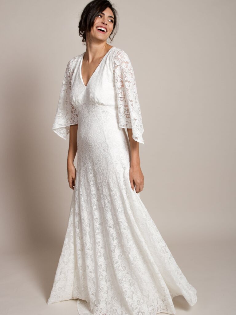 Model wears a bohemian lace wedding dress. 