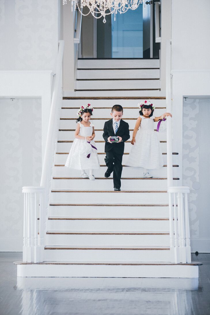 The groom's young sister, niece, and nephew kicked off the ceremony with an entrance down the white staircase.