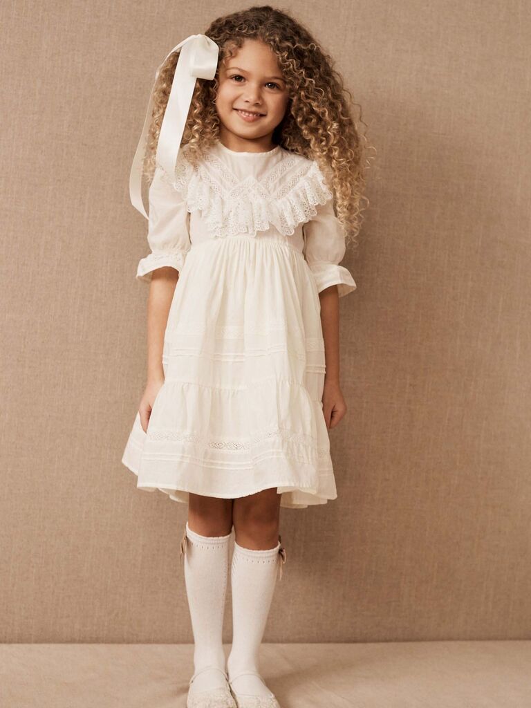 girl wearing ivory ruffle dress