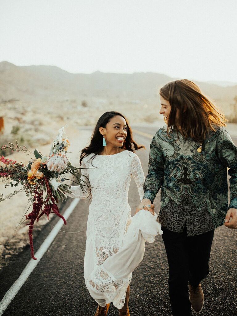 Bohemian bride wearing long sleeve boho lace wedding dress with turquoise earrings