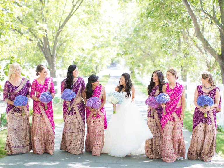 Bridesmaids wearing pink and purple sarees draped in the mermaid style.