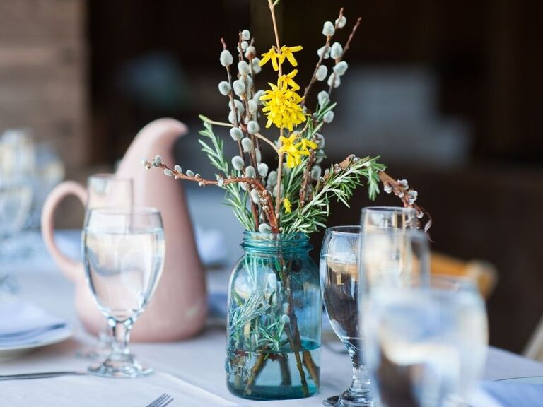 A mason jar with forsythia branches
